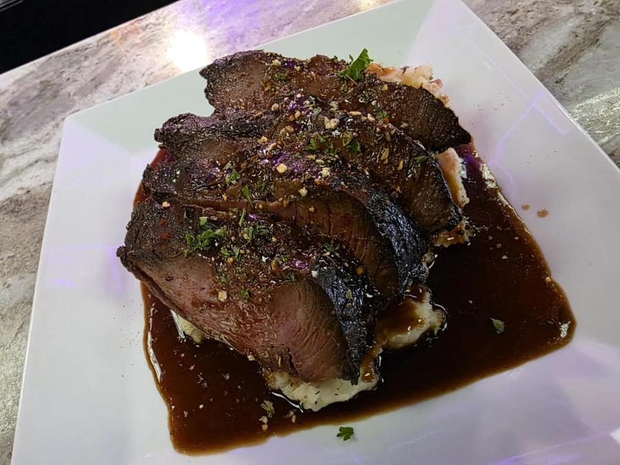 Sliced entrée with jus at Twysted Vyne, Inverness FL