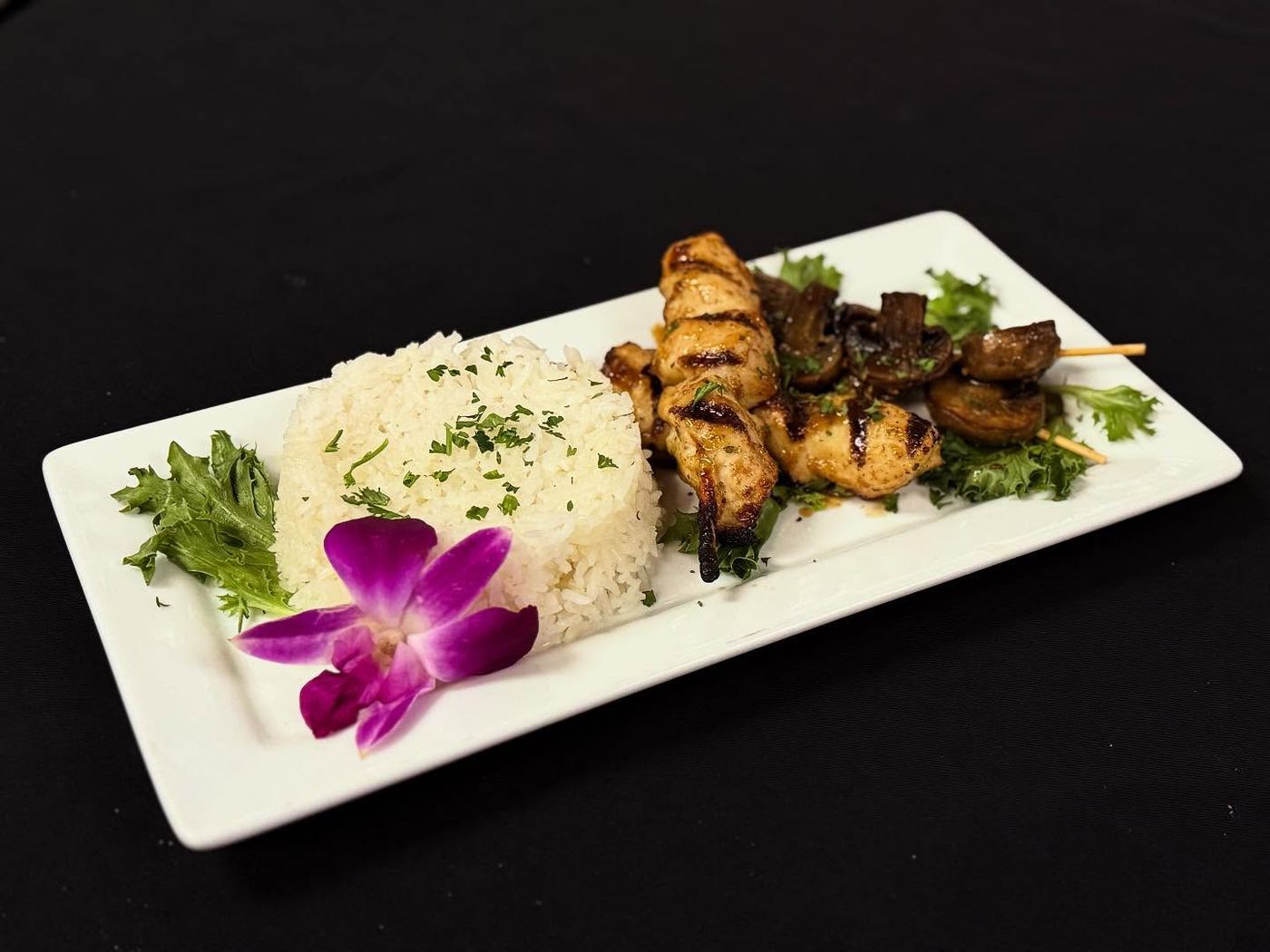 Grilled skewers over rice